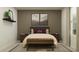Elegant bedroom featuring a queen bed, bench, decorative pillows, and nightstands with lamps at 5039 Barnet Dr, Davenport, FL 33837