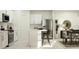 Bright kitchen featuring white cabinets, island with seating, stainless steel refrigerator, and adjacent dining area at 5039 Barnet Dr, Davenport, FL 33837
