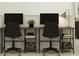 Well-lit office space with two desks, comfortable rolling chairs, and organized shelving for productivity at 5039 Barnet Dr, Davenport, FL 33837