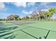 Well-maintained tennis courts surrounded by mature trees and lush greenery at 1893 Clear Sky Dr, Kissimmee, FL 34744