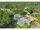 Aerial view of home featuring a sparkling pool, lush greenery, and neighborhood surroundings at 1005 Catalpa Ln, Orlando, FL 32806