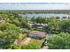 Aerial view of a single-story home with a view of a lake and lush greenery at 1005 Catalpa Ln, Orlando, FL 32806