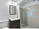 Well-lit bathroom with a modern vanity, mirror, and tiled shower with a unique star accent at 1005 Catalpa Ln, Orlando, FL 32806