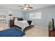 Cozy bedroom featuring a ceiling fan, window, and a comfortable bed with stylish decorations at 1005 Catalpa Ln, Orlando, FL 32806