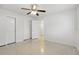 Bright bedroom with neutral paint, ceiling fan, and two closets for storage at 1005 Catalpa Ln, Orlando, FL 32806