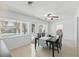 Bright dining room featuring a ceiling fan, large windows with views, and access to the outdoors at 1005 Catalpa Ln, Orlando, FL 32806
