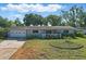Charming single-story home with a well-manicured lawn, driveway and cozy front porch at 1005 Catalpa Ln, Orlando, FL 32806