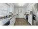 Bright kitchen with stainless steel appliances, double sink, and granite countertops at 1005 Catalpa Ln, Orlando, FL 32806