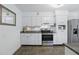 Well-lit kitchen features stainless steel appliances, granite countertops, and white cabinetry at 1005 Catalpa Ln, Orlando, FL 32806