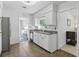 Well-lit kitchen with stainless steel refrigerator, white cabinetry, and access to laundry room at 1005 Catalpa Ln, Orlando, FL 32806
