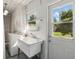 Well-lit laundry room with utility sink, washer, dryer, and a door leading to the backyard at 1005 Catalpa Ln, Orlando, FL 32806