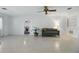 Bright living room features neutral walls and terrazzo flooring and open to dining room at 1005 Catalpa Ln, Orlando, FL 32806