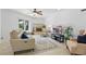 Living room features a decorative fireplace, comfortable seating, and a ceiling fan at 1005 Catalpa Ln, Orlando, FL 32806