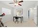 Comfortable office space featuring exercise equipment, a desk, and views to other rooms at 1005 Catalpa Ln, Orlando, FL 32806