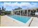 Inviting pool with a covered patio, perfect for outdoor relaxation and entertaining under black curtains at 1005 Catalpa Ln, Orlando, FL 32806