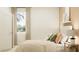 Bright bedroom featuring neutral walls, a patterned bedspread, and a window with natural light at 286 Puma Loop, Groveland, FL 34736