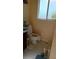Bathroom with toilet, vanity and window at 602 Hillcrest Dr, Davenport, FL 33897