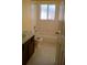 The bathroom has brown cabinets, shower over tub and ceramic tile at 602 Hillcrest Dr, Davenport, FL 33897