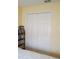Bedroom showing closet doors with a full bookshelf nearby at 602 Hillcrest Dr, Davenport, FL 33897