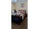 Comfortable bedroom featuring carpet floors, a queen-size bed, and traditional furnishings at 602 Hillcrest Dr, Davenport, FL 33897