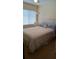 The bedroom has carpet, a fan and a large window at 602 Hillcrest Dr, Davenport, FL 33897