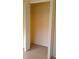 Bedroom closet features shelving, neutral carpeting, and bi-fold doors at 602 Hillcrest Dr, Davenport, FL 33897