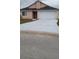 Single-Gathering home featuring an attached garage and driveway with front yard landscaping at 602 Hillcrest Dr, Davenport, FL 33897