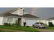 Suburban home with an attached garage, driveway, and green lawn under a vibrant rainbow sky at 602 Hillcrest Dr, Davenport, FL 33897