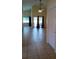 Spacious living room featuring neutral tile floors, large windows, and a sliding glass door to the backyard at 602 Hillcrest Dr, Davenport, FL 33897