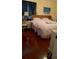 Main bedroom with white bedding, hardwood floors and neutral colored walls at 602 Hillcrest Dr, Davenport, FL 33897