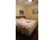 Main bedroom with white bedding, ceiling fan and art on the wall at 602 Hillcrest Dr, Davenport, FL 33897