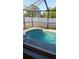 Sparkling pool within screened enclosure for outdoor enjoyment and privacy at 602 Hillcrest Dr, Davenport, FL 33897