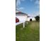 A suburban home with an attached garage and a fenced yard with grass at 602 Hillcrest Dr, Davenport, FL 33897