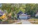 Inviting single-story home featuring mature trees and landscaping in a peaceful neighborhood at 6125 Morningdale Ave, Lakeland, FL 33813