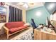 A bedroom with a red futon, desk, and black curtains, offering a versatile space at 6125 Morningdale Ave, Lakeland, FL 33813