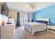 Bedroom featuring a queen-size bed, a window, and neutral-colored walls with one blue accent wall at 6125 Morningdale Ave, Lakeland, FL 33813
