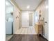 Bright entryway featuring tile floors, neutral walls and front door with convenient laundry area at 6125 Morningdale Ave, Lakeland, FL 33813