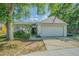 Charming single-story home featuring an attached garage, mature trees, and appealing landscaping at 6125 Morningdale Ave, Lakeland, FL 33813