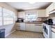 Well-lit kitchen featuring modern appliances, tiled floor and large window for natural light at 6125 Morningdale Ave, Lakeland, FL 33813