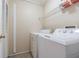 Laundry room with a washer and dryer, along with a wire rack for storage, offering convenience at 6125 Morningdale Ave, Lakeland, FL 33813