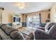 Cozy living room features comfortable seating, modern entertainment center and sliding door access to the yard at 6125 Morningdale Ave, Lakeland, FL 33813