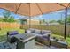 Outdoor patio area offers comfortable seating, a fire pit, and a view of the fenced yard at 6125 Morningdale Ave, Lakeland, FL 33813