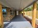 Covered back porch with brick columns, wood supports, and concrete floor at 1011 Old Lake Alfred Rd, Auburndale, FL 33823