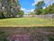 Expansive fenced backyard with lush green grass, mature trees, and space for entertaining at 1011 Old Lake Alfred Rd, Auburndale, FL 33823