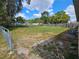 Large fenced-in backyard featuring chain link fence offering ample space for outdoor activities at 1011 Old Lake Alfred Rd, Auburndale, FL 33823