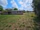 Grassy backyard with fences, providing a great space for outdoor entertaining or relaxation at 1011 Old Lake Alfred Rd, Auburndale, FL 33823