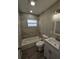 Updated bathroom showcasing modern vanity, tiled shower and tub combination, and stylish lighting at 1011 Old Lake Alfred Rd, Auburndale, FL 33823