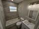 Remodeled bathroom featuring stylish fixtures, tiled shower and tub, and modern vanity at 1011 Old Lake Alfred Rd, Auburndale, FL 33823