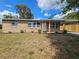 Charming brick home with a covered carport and freshly landscaped front yard at 1011 Old Lake Alfred Rd, Auburndale, FL 33823