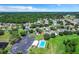 Aerial view showcasing community pool, parking, and residential homes nestled among trees at 2076 Whispering Trails Blvd, Winter Haven, FL 33884